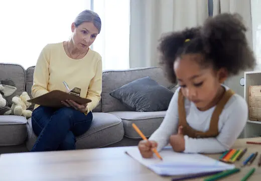 Psychologist, clipboard and child with drawing for education, learning behavior and assessment for adhd Psychologist, clipboard and child with drawing for education, learning behavior and assessment for adhd